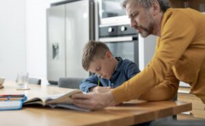 close-up-father-helping-kid-with-homework