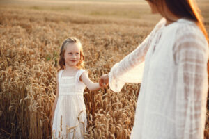 Mother with daughter playing in a summer field
