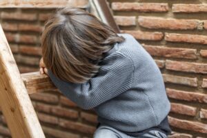 little-boy-outdoors-upset