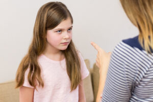 Mother scolding her daughter in living room