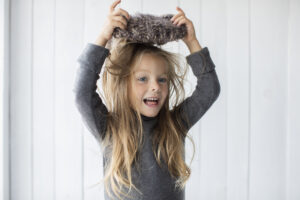 adorable-blonde-girl-playing-with-winter-hat