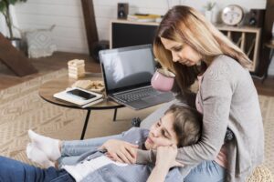 mother-working-from-home-hugging-her-son